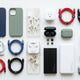 mobile accessories including phone cases, charging cables, earbuds, power banks arranged neatly 