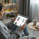 Woman browsing discounted cheap smartphones online at home.