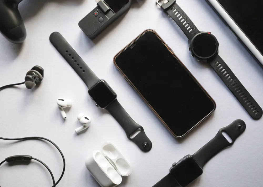 Flat lay of mobile phone accessories including chargers, earbuds, and cases on a white background.