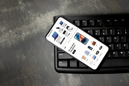A smartphone displaying an online shopping interface for electronics and clothing.