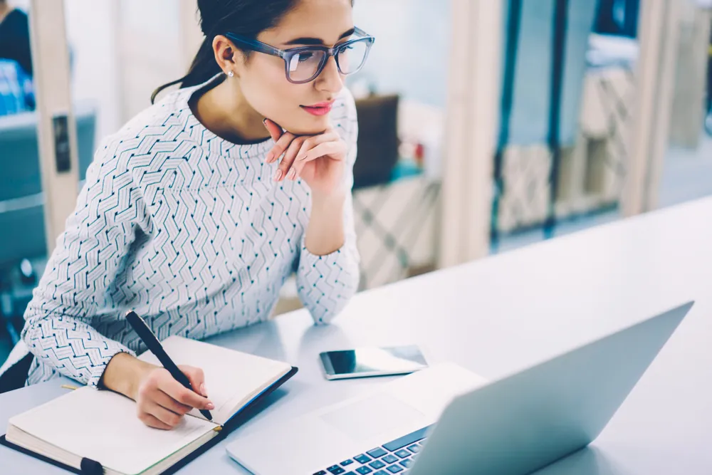 A woman doing research when creating a business plan